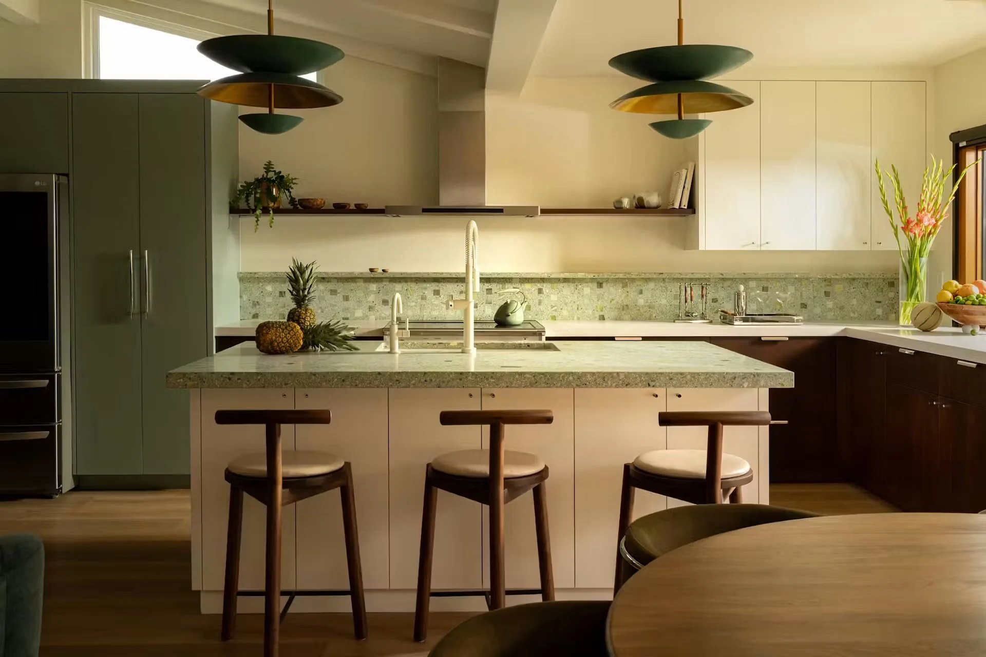 A mid-century modern kitchen with a green backsplash and countertop.
