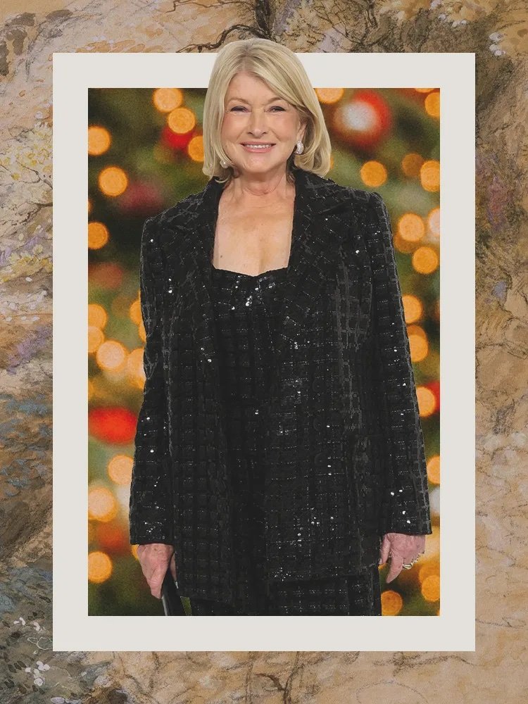 Smiling Martha Stewart in a black, shimmering pantsuit.