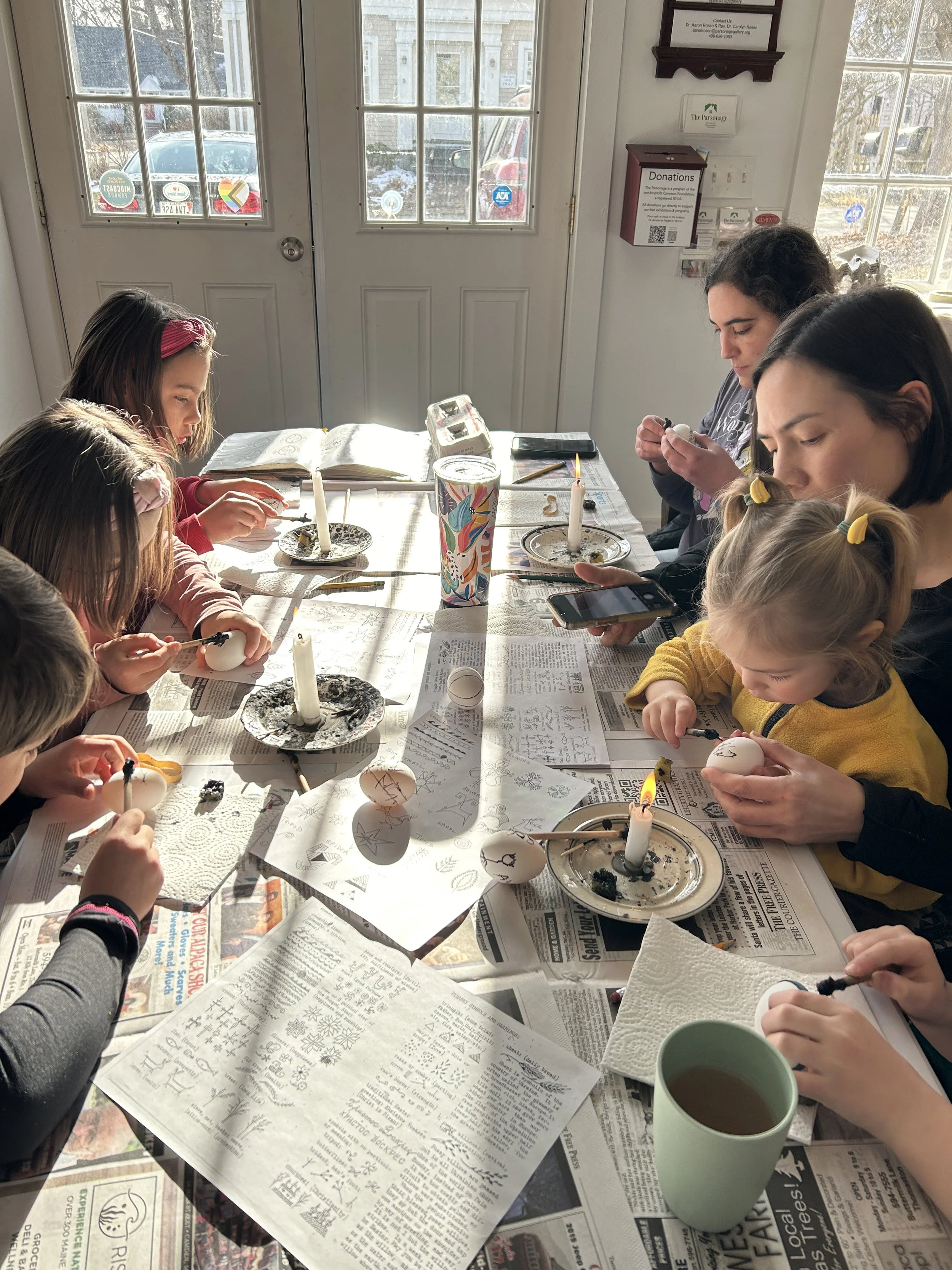 Sarah's kids doing eggs.JPG