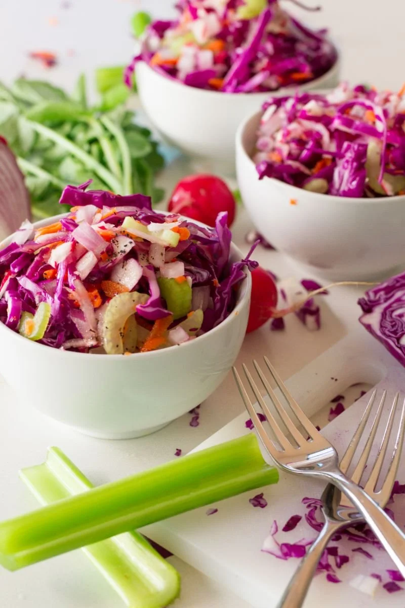 Colorful red cabbage salad with fresh vegetables.