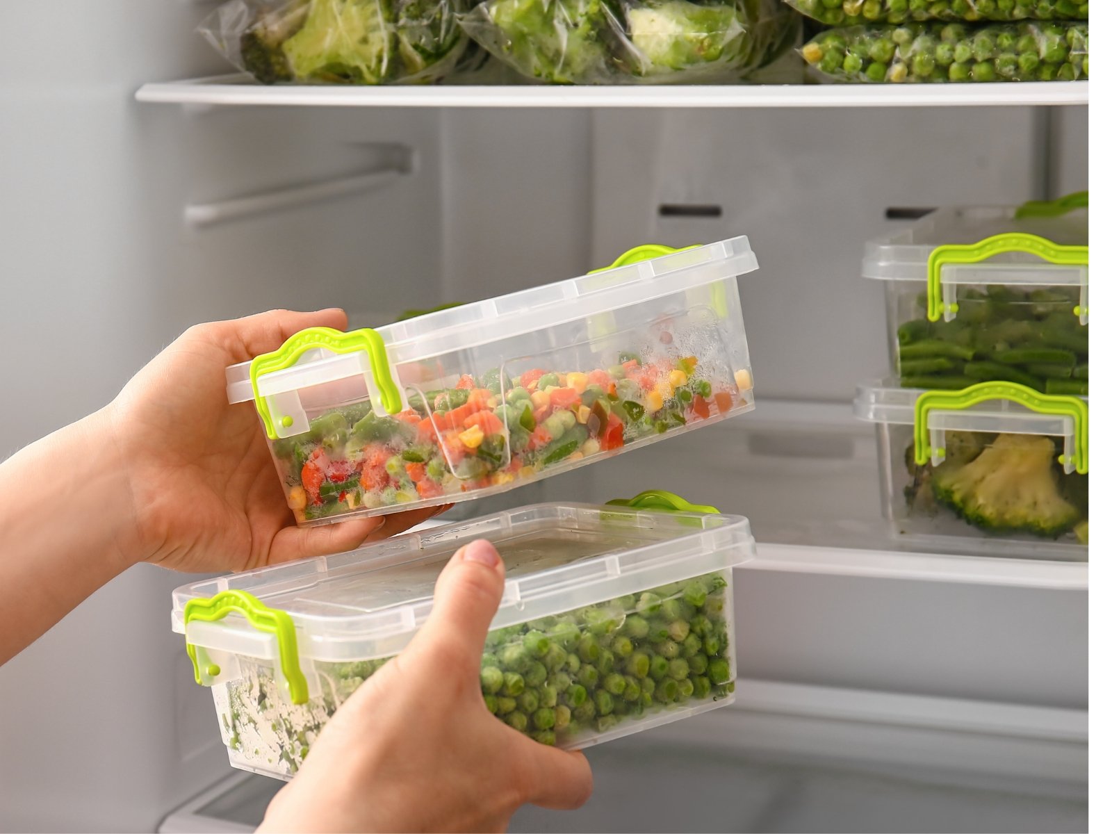 Prepared vegetables stored in clear containers in a refrigerator