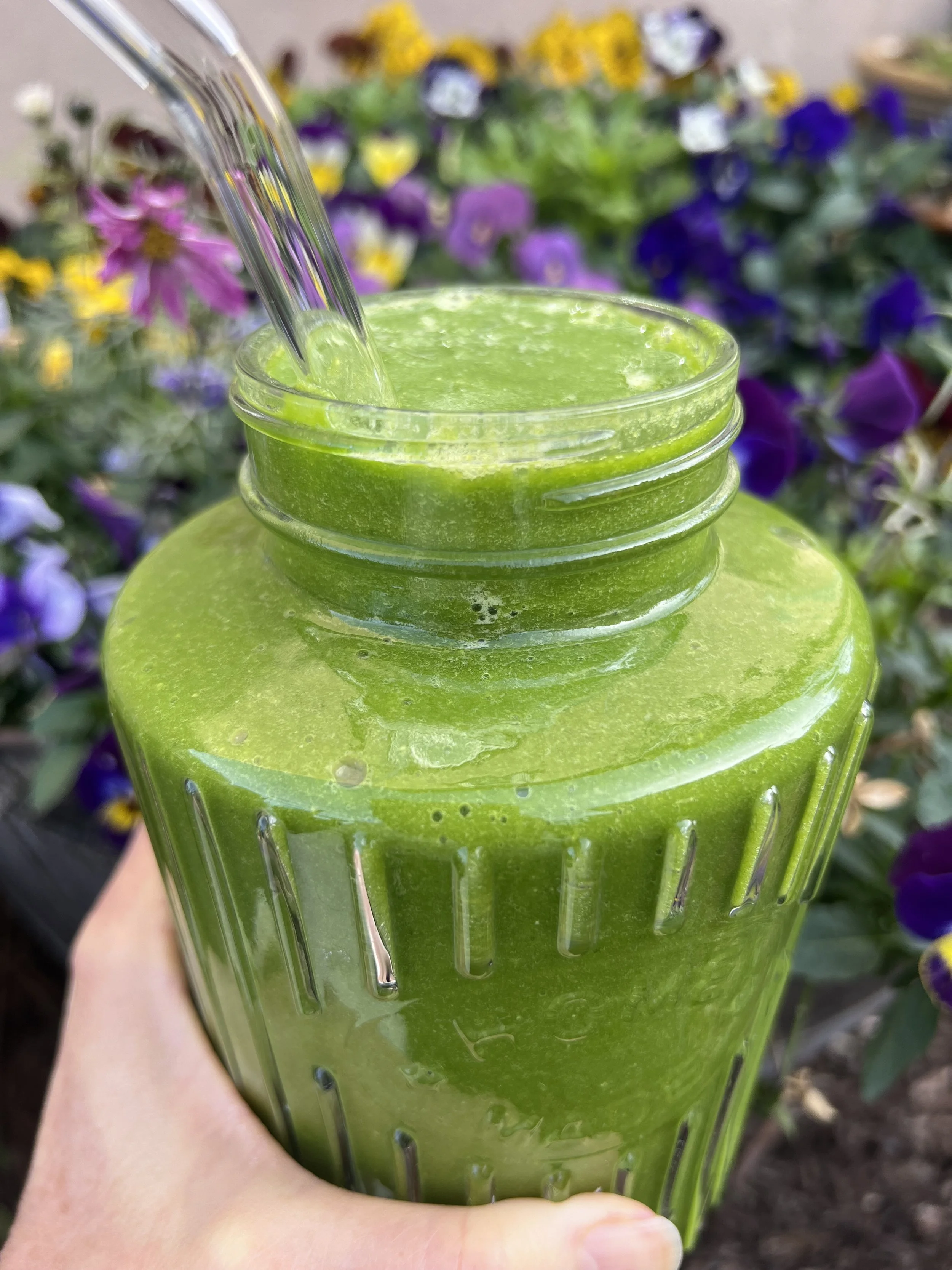 Homemade hyper-nourishing green smoothie made with leafy greens, fruit and omega-3-rich seeds.
