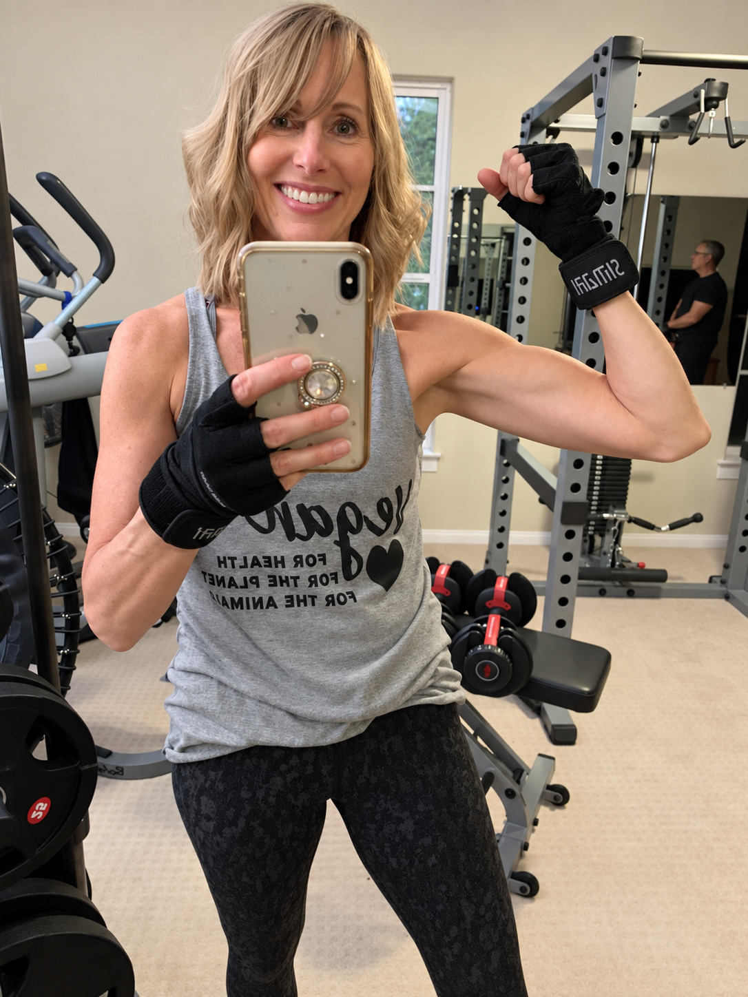 Michelle strength training in her home gym while discussing plant-based protein and muscle health