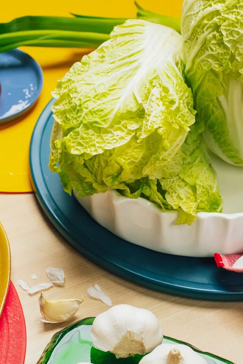 Fresh napa cabbage being prepared for homemade vegan kimchi.