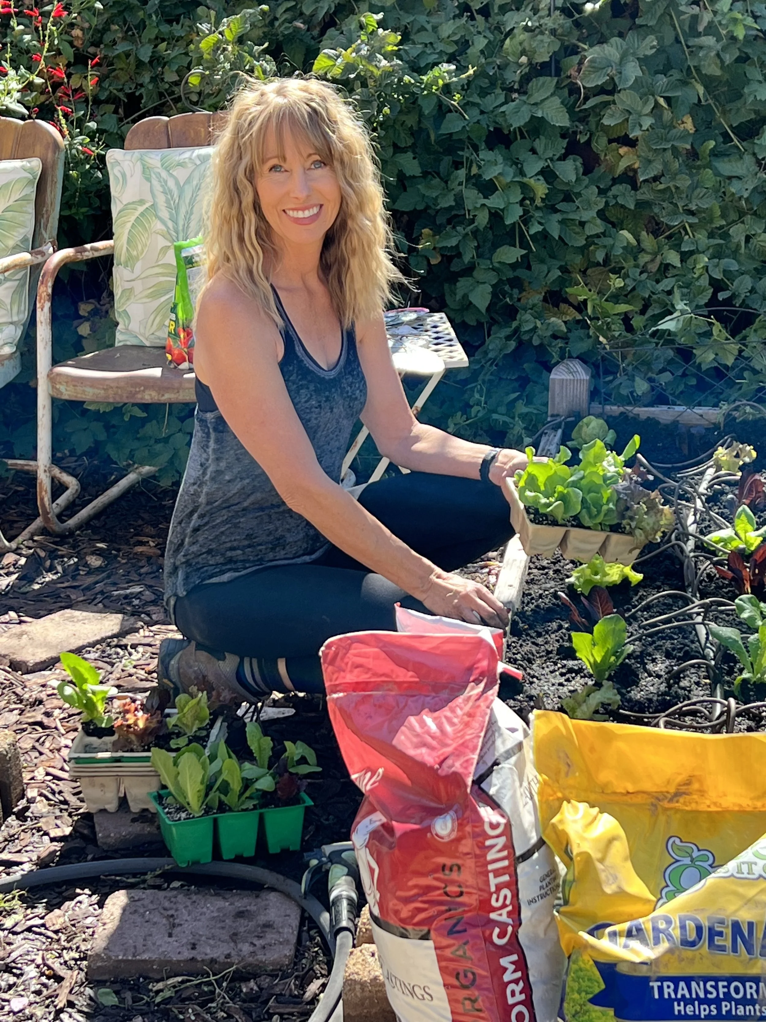 Michelle gardening in raised beds and growing fresh vegetables for a whole-food plant based lifestyle