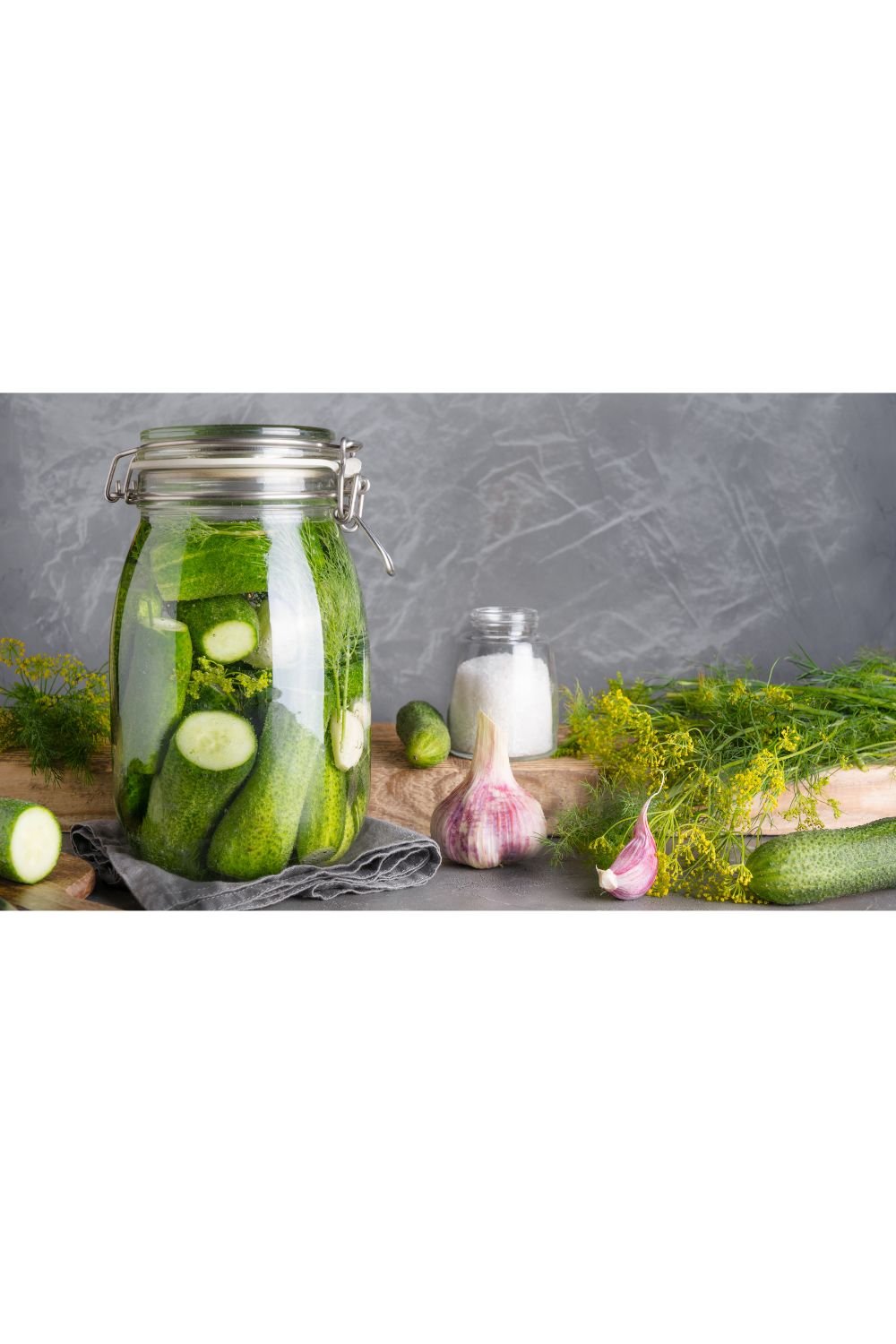 Homemade fermented garlic dill pickles made with cucumbers, fresh dill, garlic, and sea salt.