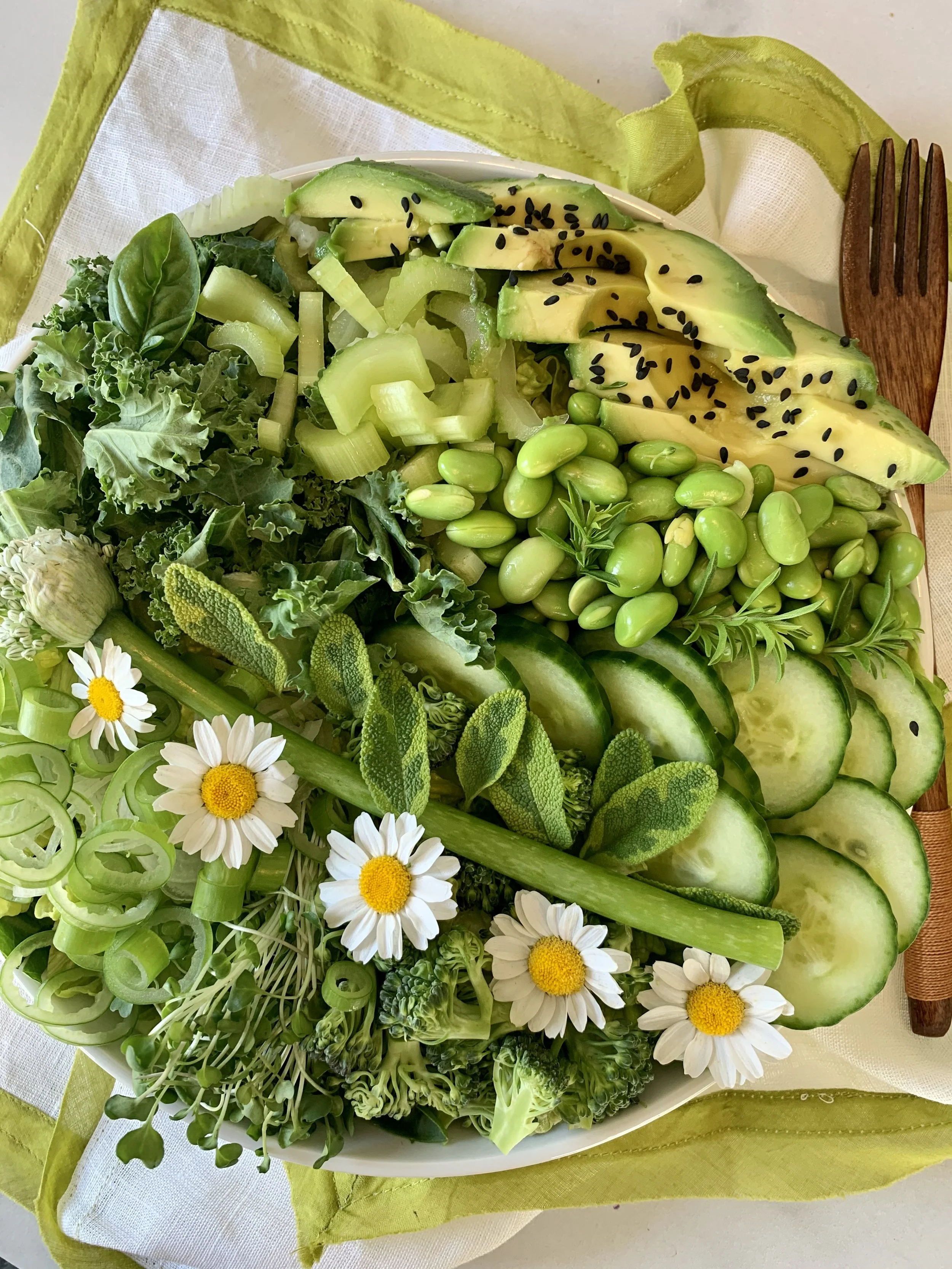 Colorful plant-based lunch with edamame, avocado, leafy greens, cucumber, asparagus, and vegetables