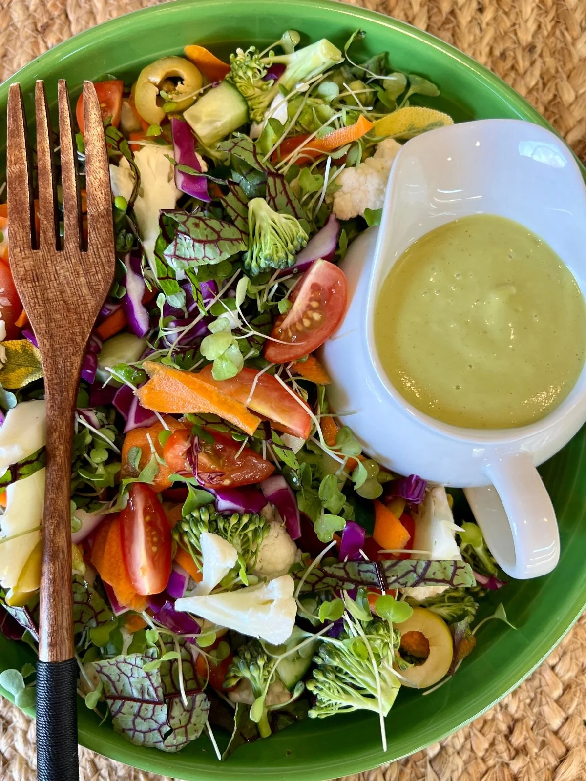 Colorful salad with leafy greens, red cabbage, broccoli, vegetables, and sprouts