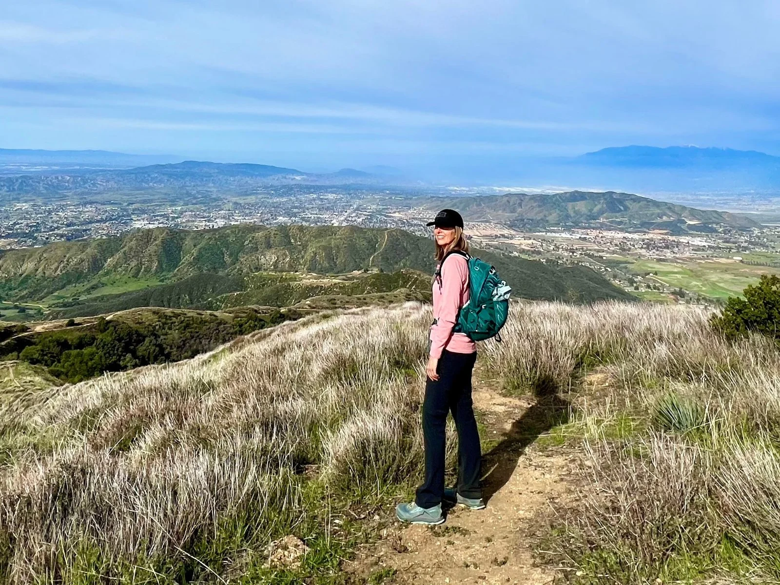 Michelle walking on a mountain trail during an outdoor hike.
