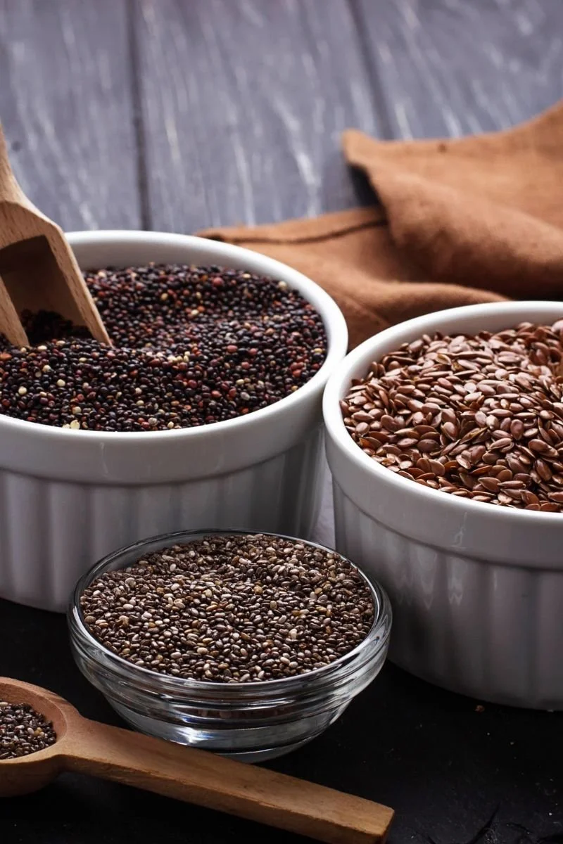 Bowls of chia seeds and flax seeds used as plant-based omega-3 sources.