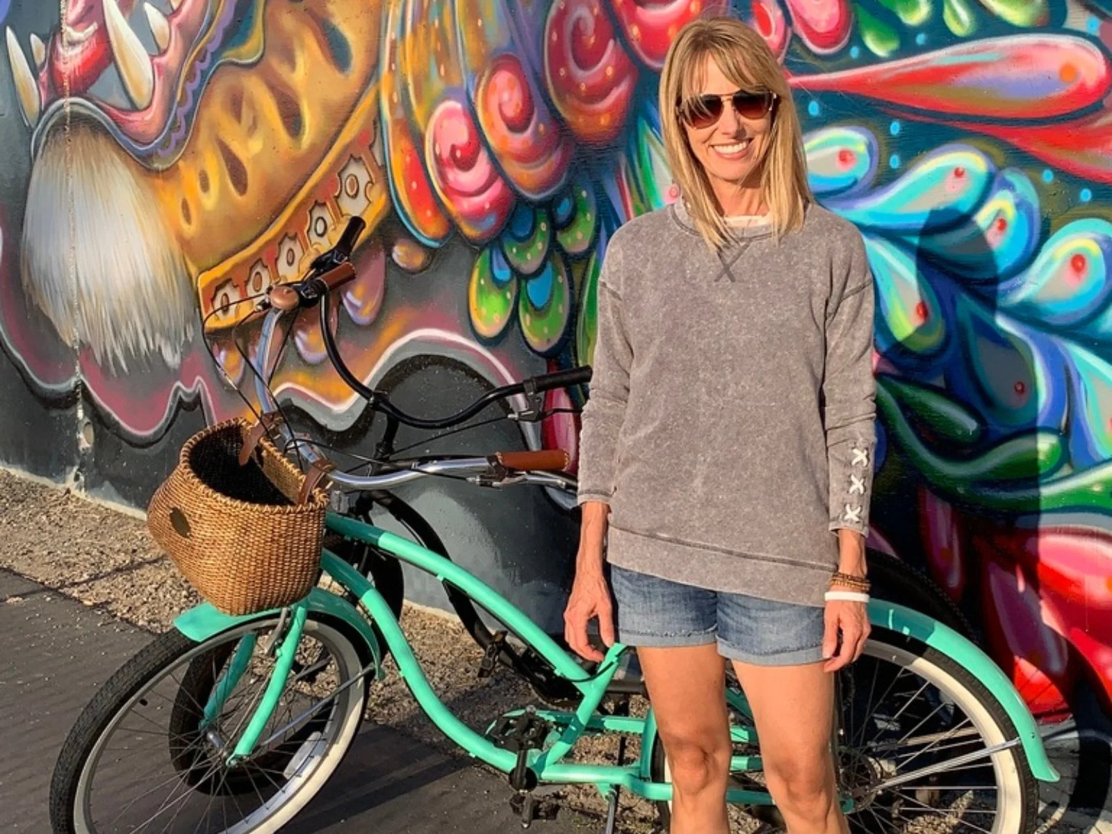 Michelle standing beside her beach cruiser during an outdoor bike ride