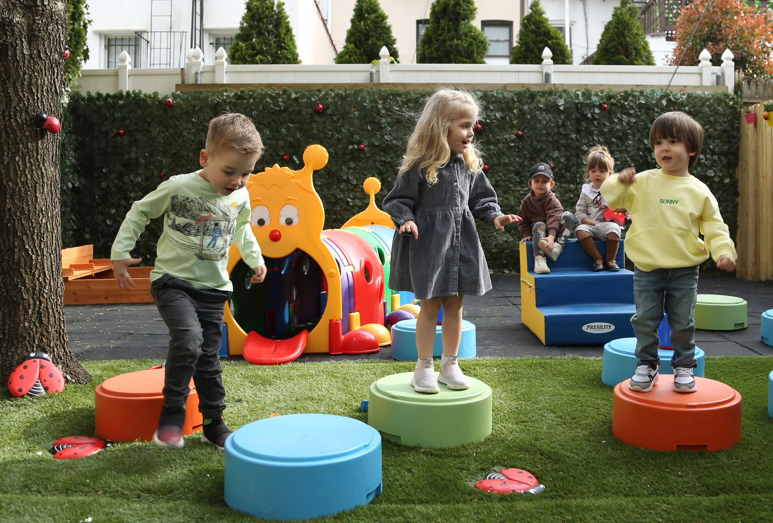 Children playing outdoors during summer camp at Ladybug, Carroll Gardens Brooklyn