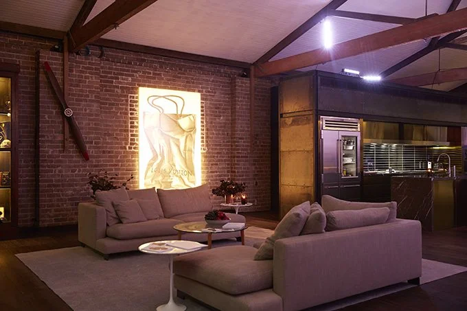 Living area and neon artwork at Herm Inn warehouse