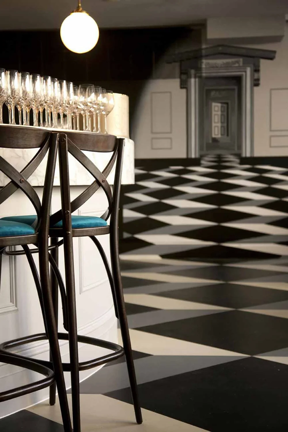 Bar stool and graphic tile floor detail at a bar