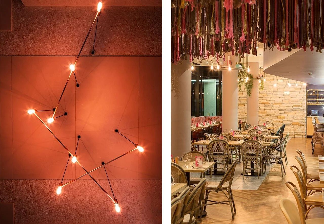 Interior detail of agostinins restaurant in canberra showcasing a geometric structural light fitting and dining area