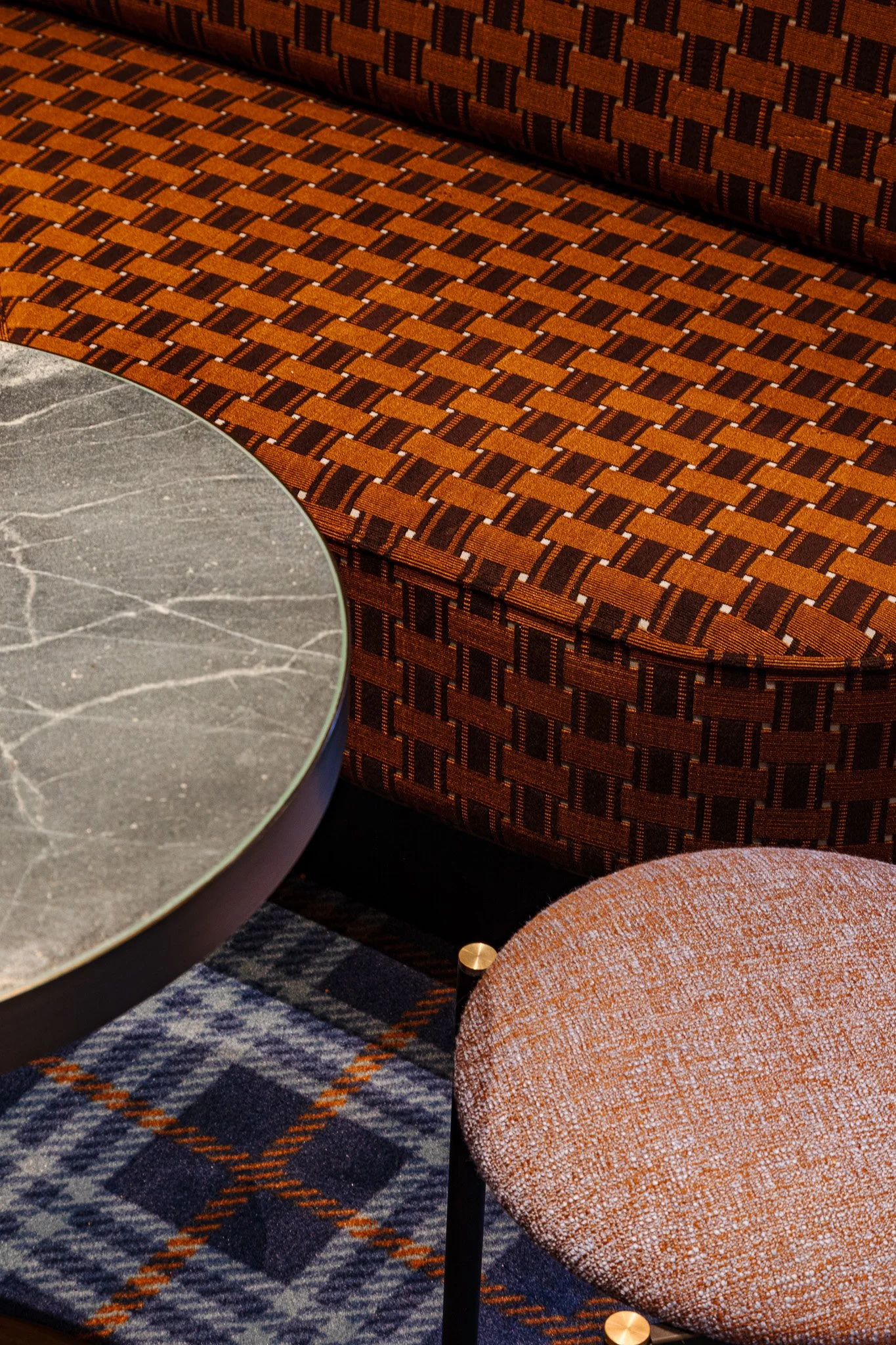 Plaid carpet, patterned upholstery fabric and marble bar table at Allianz Stadium Private suite