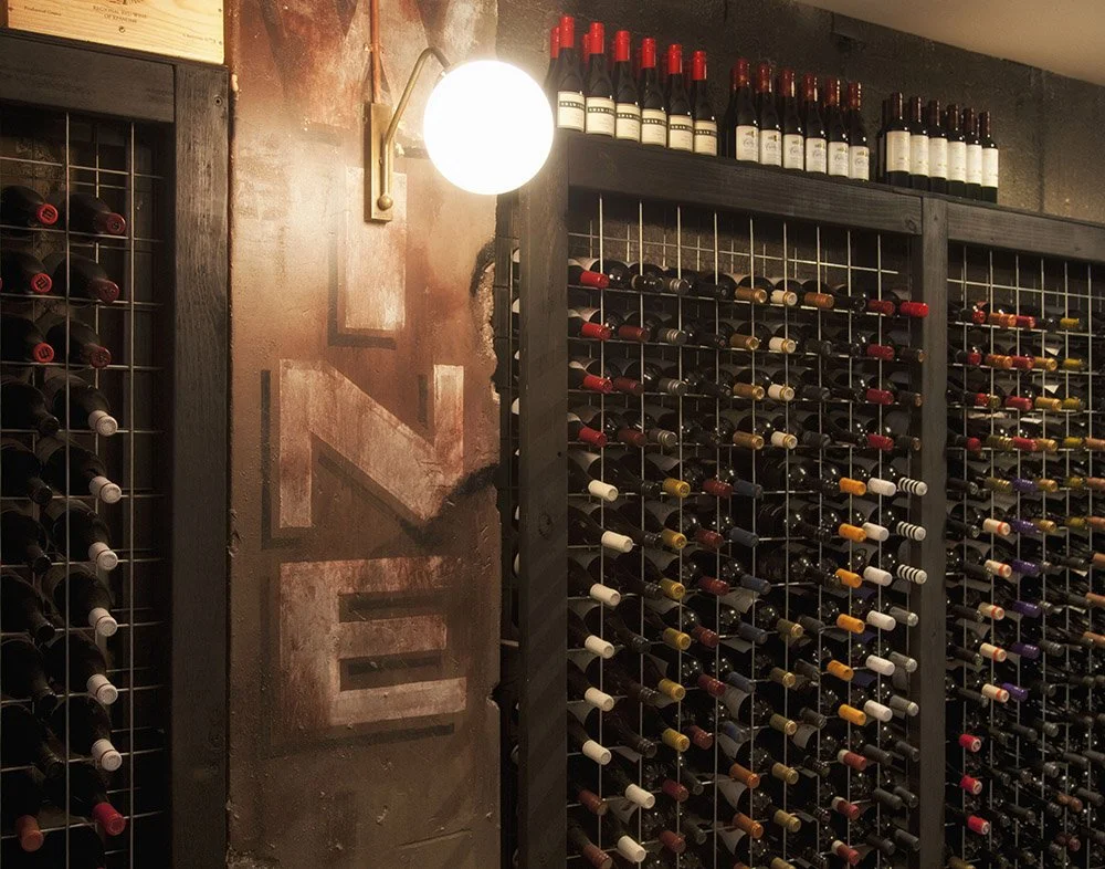 Wine rack and scenic mural at a bar at Bondi Junction, designed by Kelly Ross