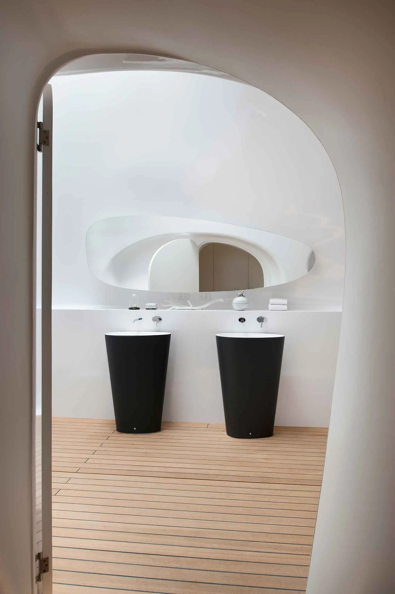 Bathroom sinks and mirror with organic curves in a residential warehouse in Sydney