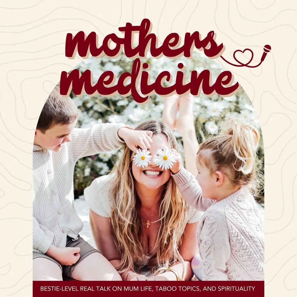 A joyful scene featuring a mother with two children, each holding daisies over her eyes, all smiling and sitting outdoors with a floral background. The text "mothers medicine" is displayed above, and a smaller text below reads, "bestie-level real talk on mum life, taboo topics, and spirituality."