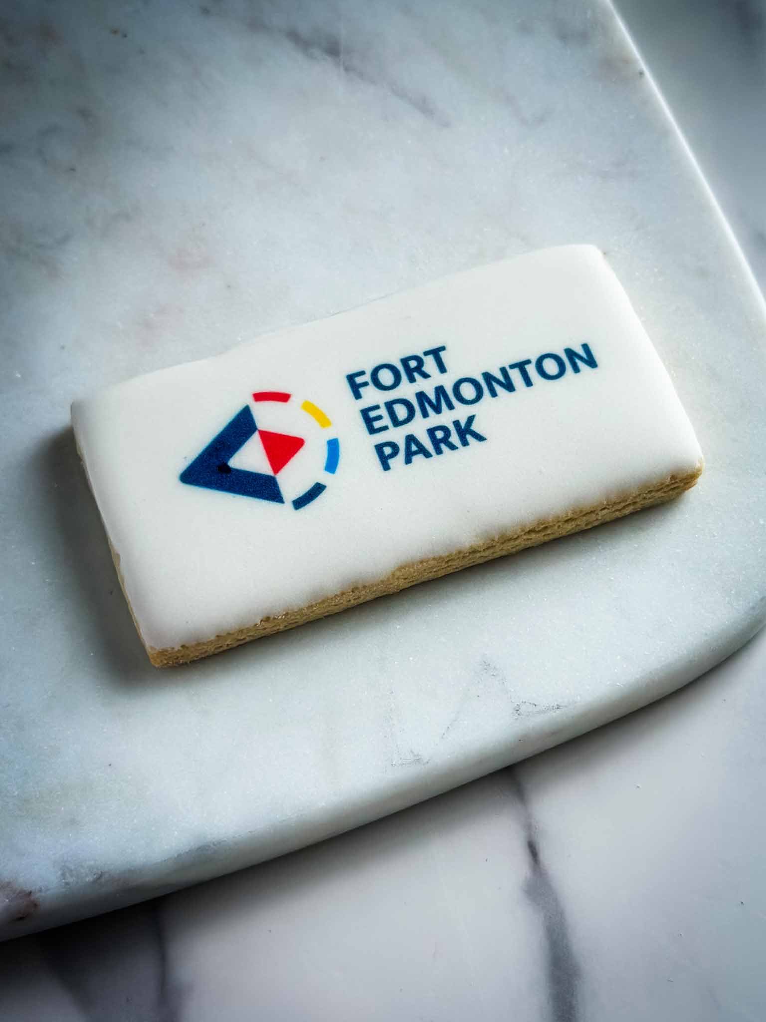 A Worthy Cookie Custom Sugar Cookies Large Rectangle Logo Cookie on a marble plate.jpg
