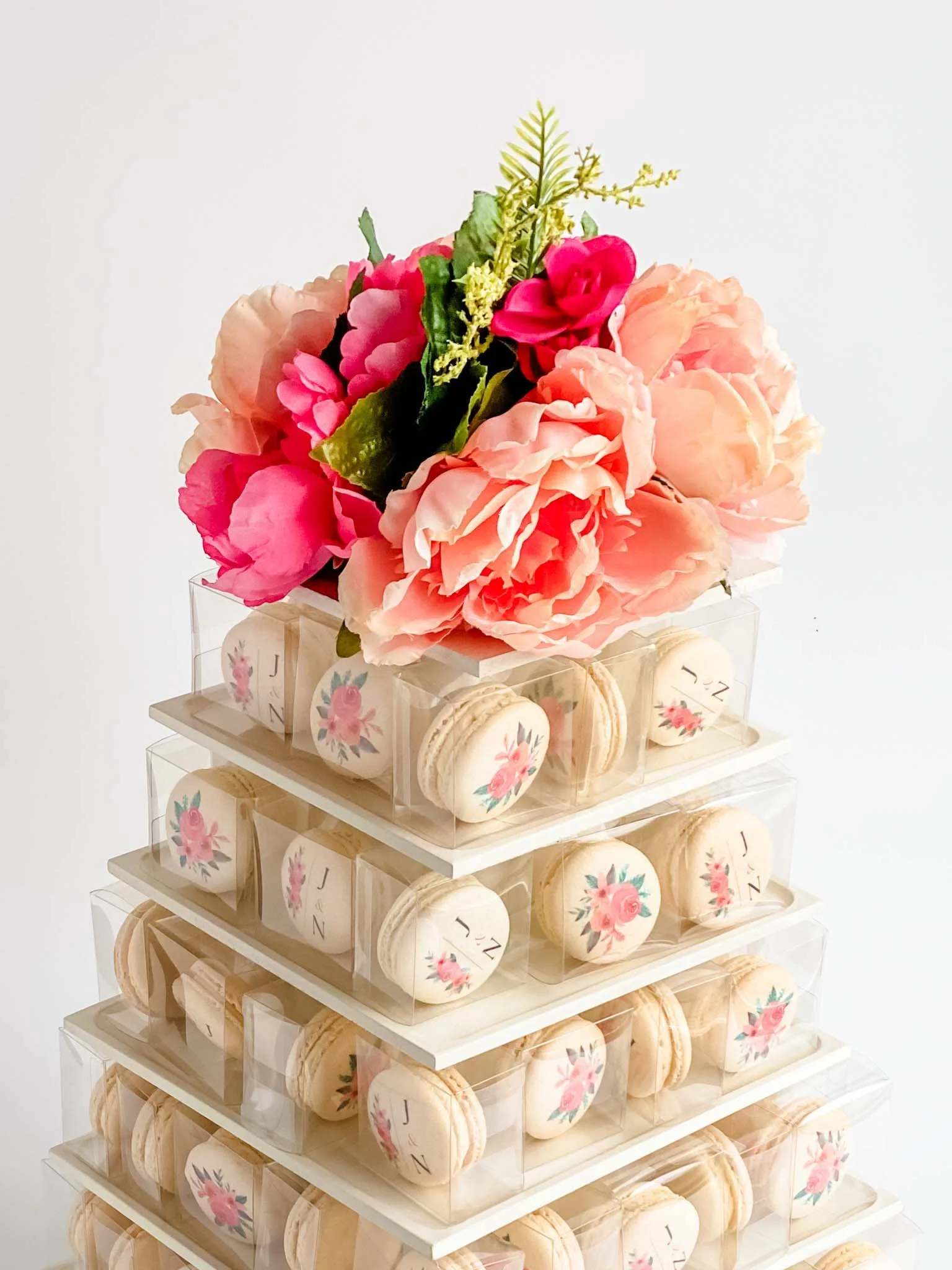 A Worthy Cookie engagement macaron tower with coral pink flower topper.jpg