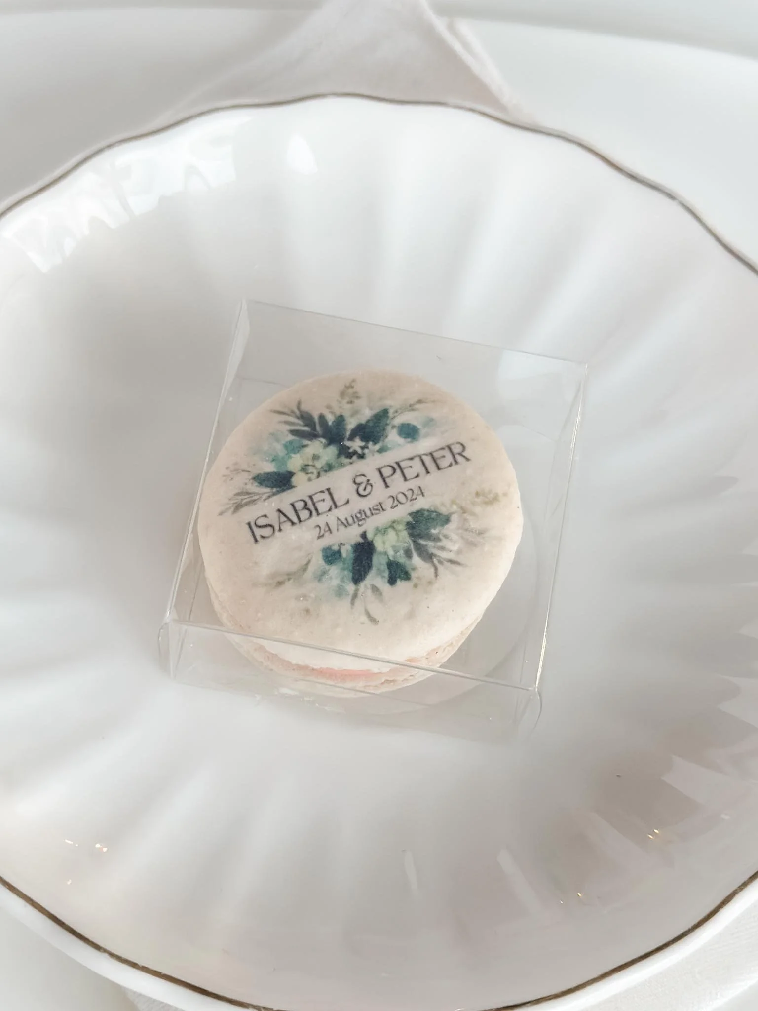A Worthy Cookie individually boxed macaron with names and greenery on top of plate setting.jpg