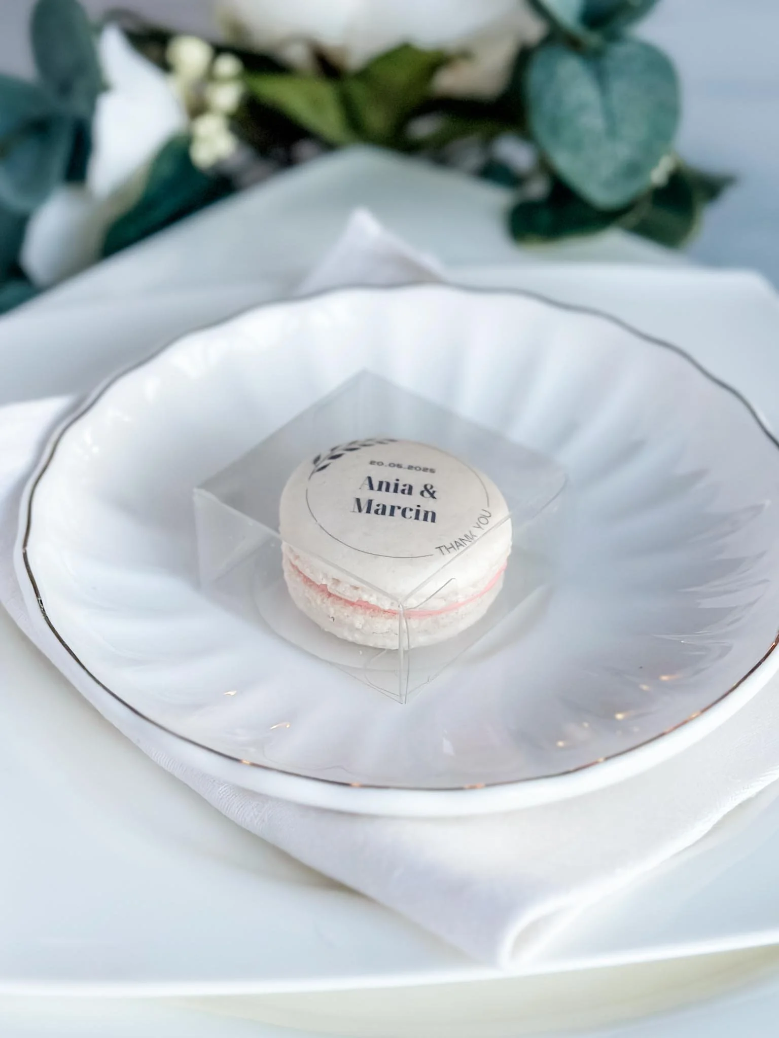 A Worthy Cookie individually boxed macaron with bride and groom's names on top of plate setting.jpg