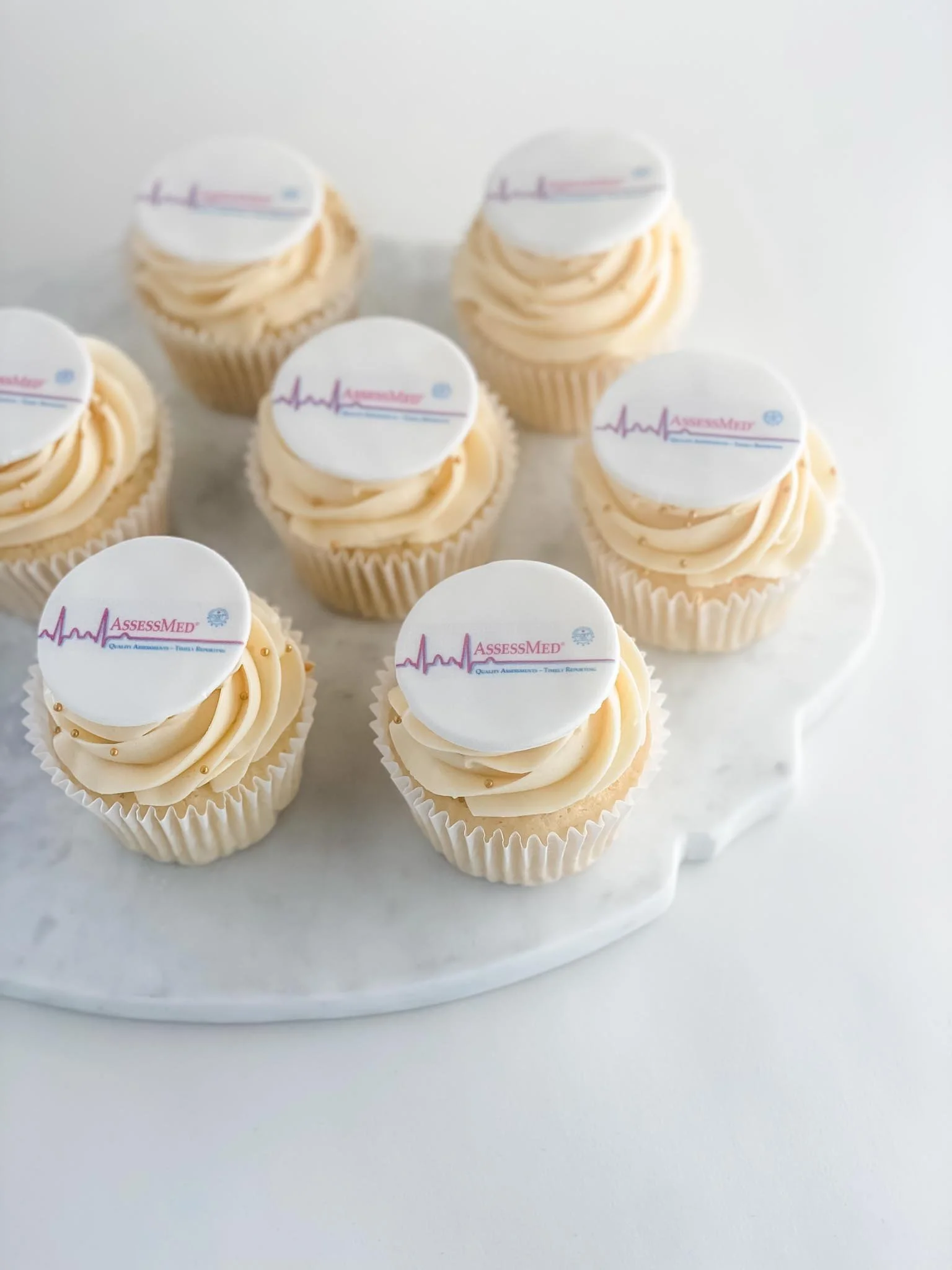 A Worthy Cookie vanilla cupcakes with medical logo.jpg