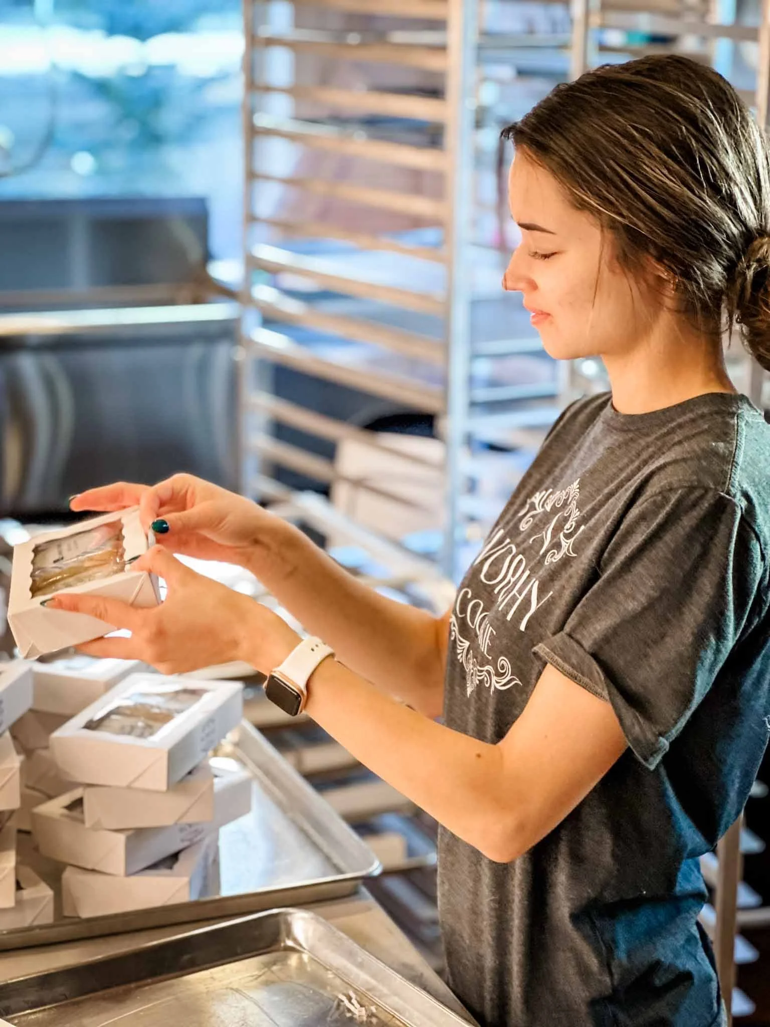A Worthy Cookie Izabel labelling boxes of cookies.jpg