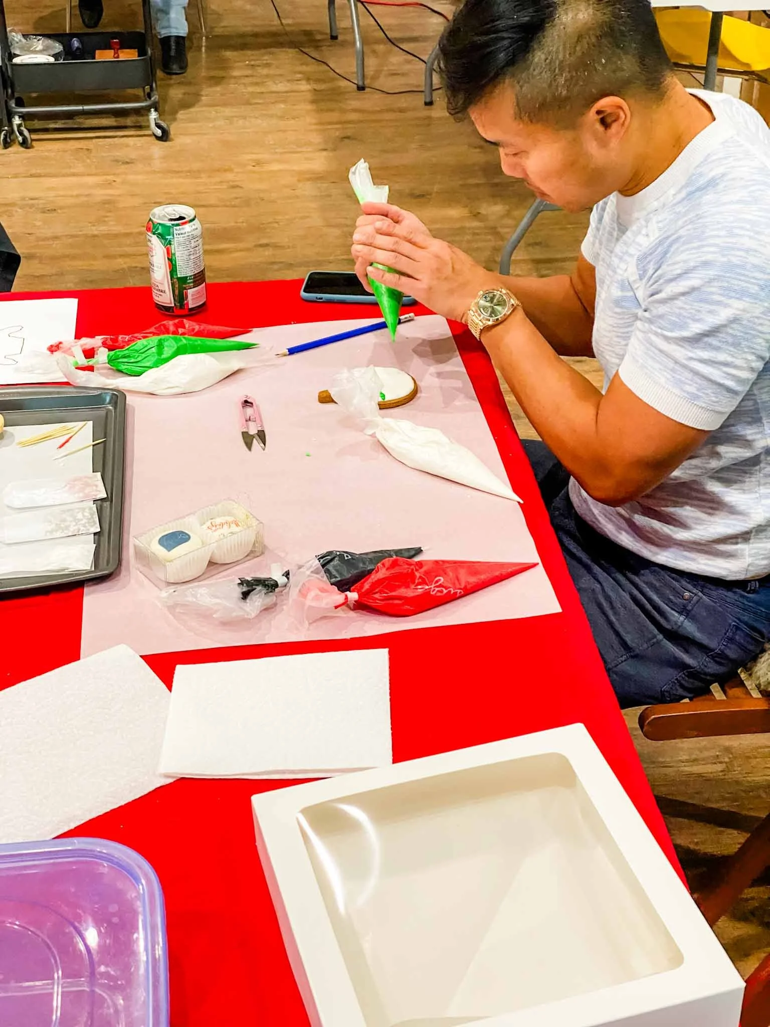A Worthy Cookie Sugar Cookie decorting class man decorating christmas sweater cookie.jpg