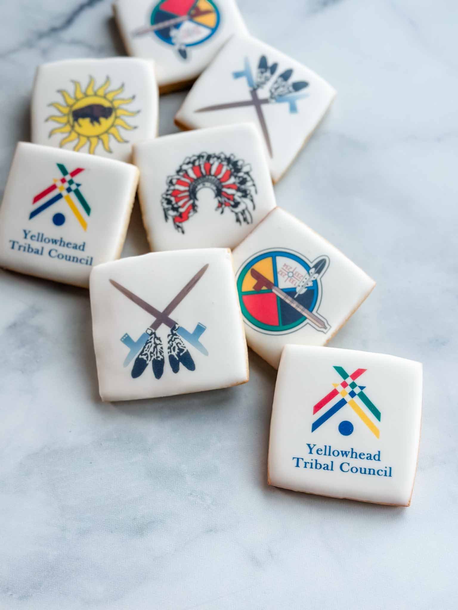 A Worthy Cookie row of large sugar cookies with first nations logos.jpg