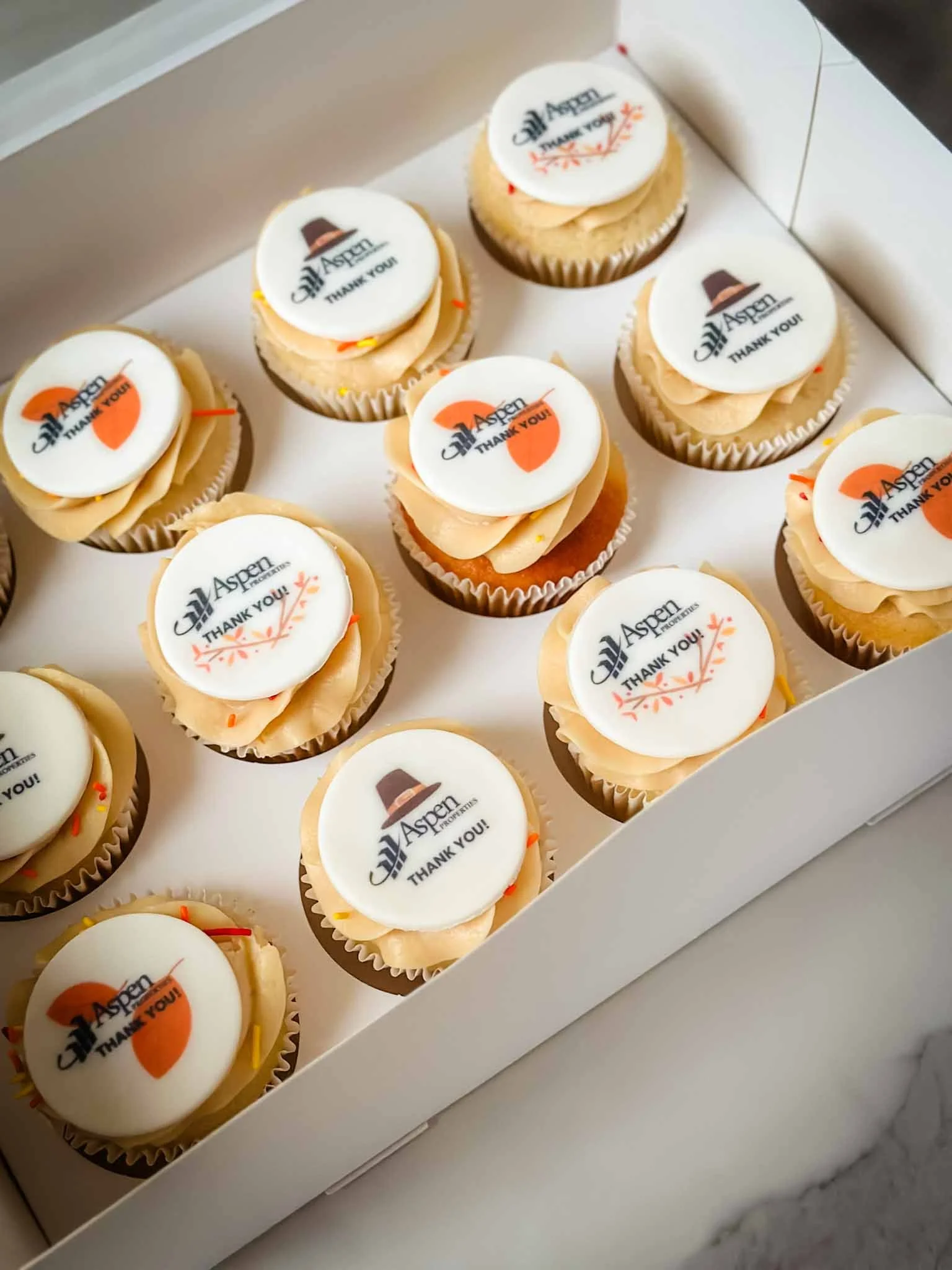 Branded corporate cupcakes with custom company logos printed on edible toppers