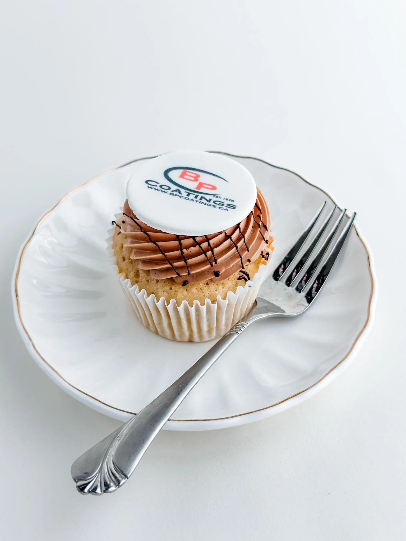 A Worthy Cookie bp coatings logo cupcake on a plate.jpg