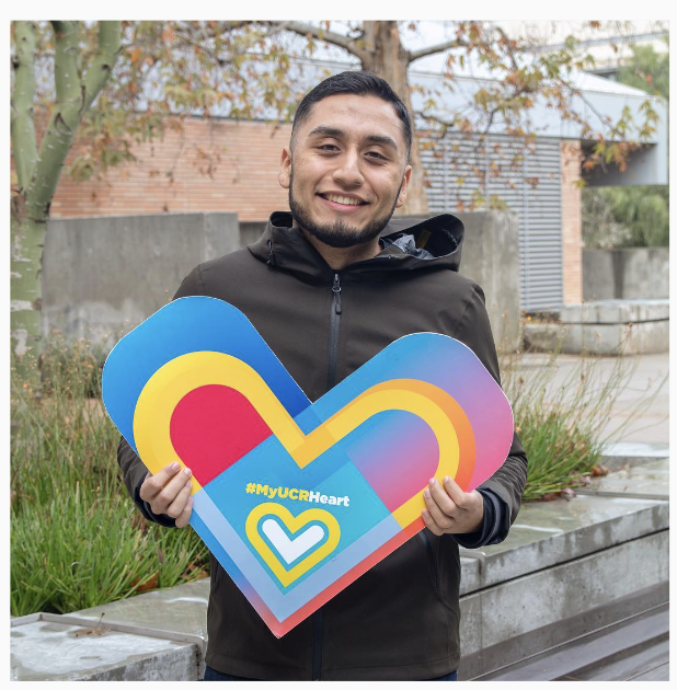  A person holds up a paper heart 