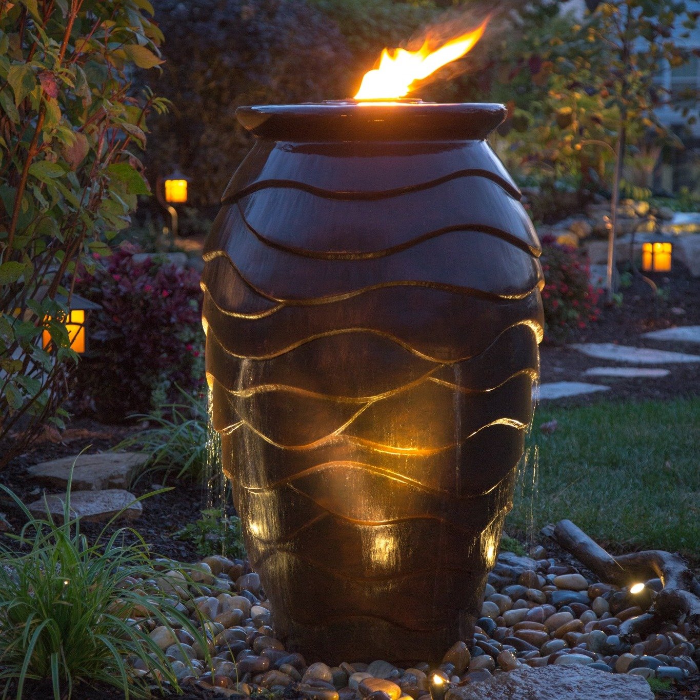 Big impact. Small footprint. 🔥💧

This custom fountain blends flowing water with a live fire feature &mdash; creating a stunning focal point that fits beautifully in any size yard.

Compact enough for patios and courtyards.
Bold enough to transform 