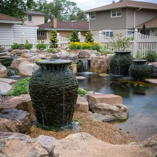 Your backyard should feel as refined as the home it surrounds.

A fire + water urn creates a striking focal point &mdash; where flowing water meets a warm flame, bringing movement, light, and atmosphere to your outdoor space.

By day, it&rsquo;s a sc