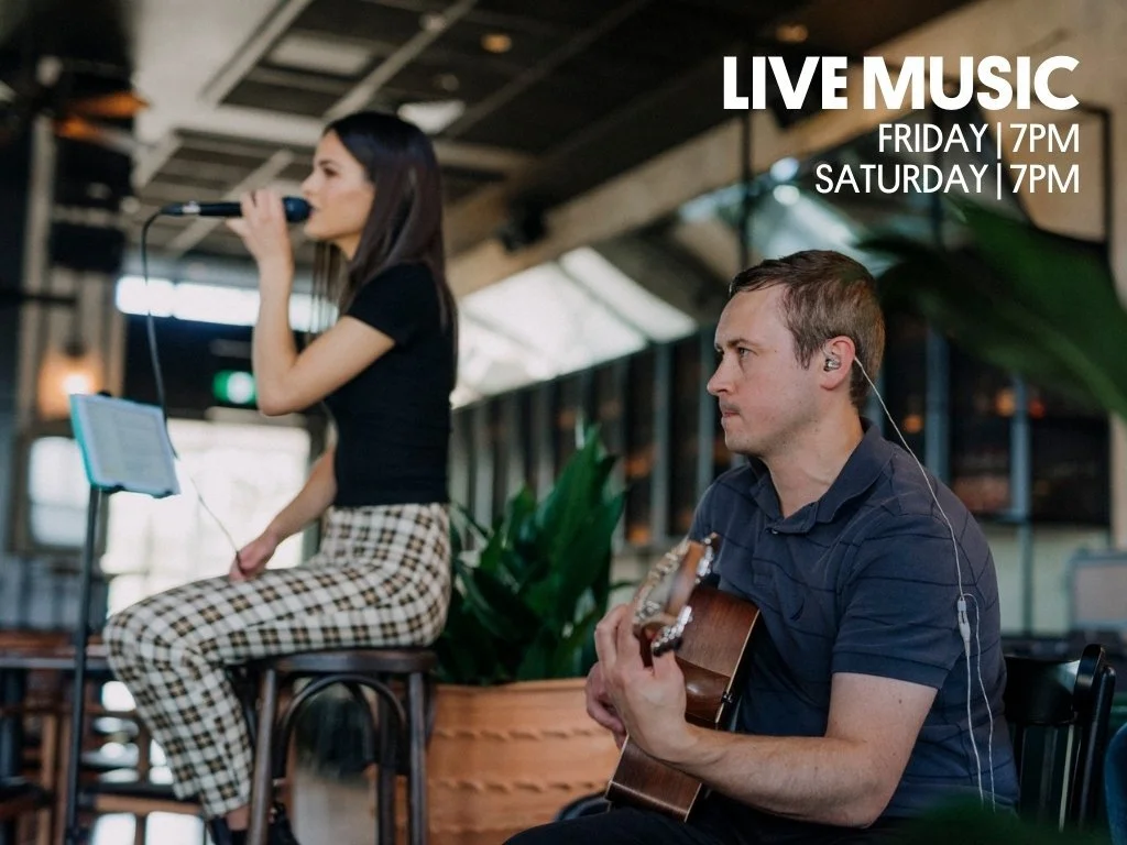 A female singer and a male guitarist performing live music in a venue, promotional text indicates live performances on Friday and Saturday at 7 PM.