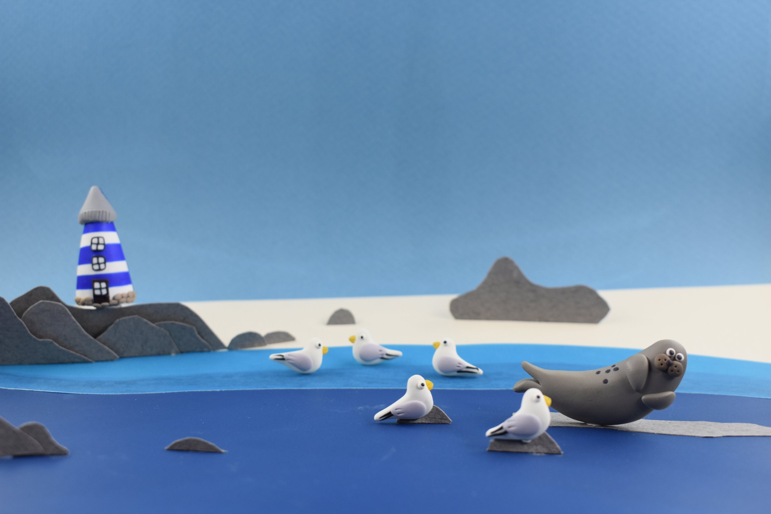 By the lighthouse! Seagulls and seals by the beach.