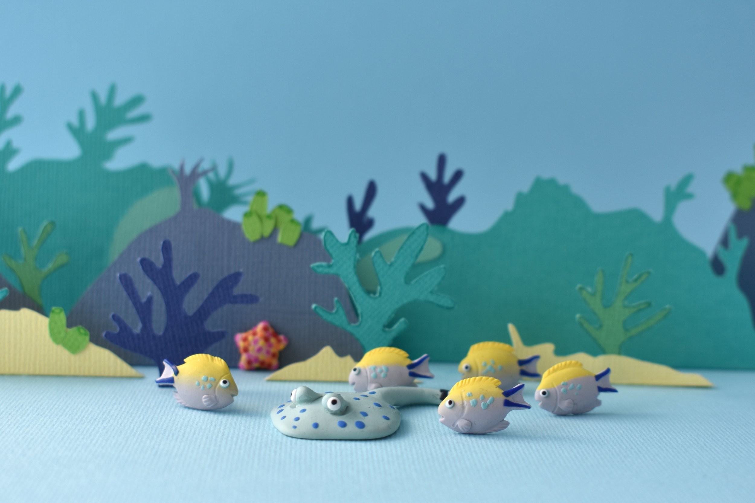 Angelfish and a blue spotted stingray amidst the corals.