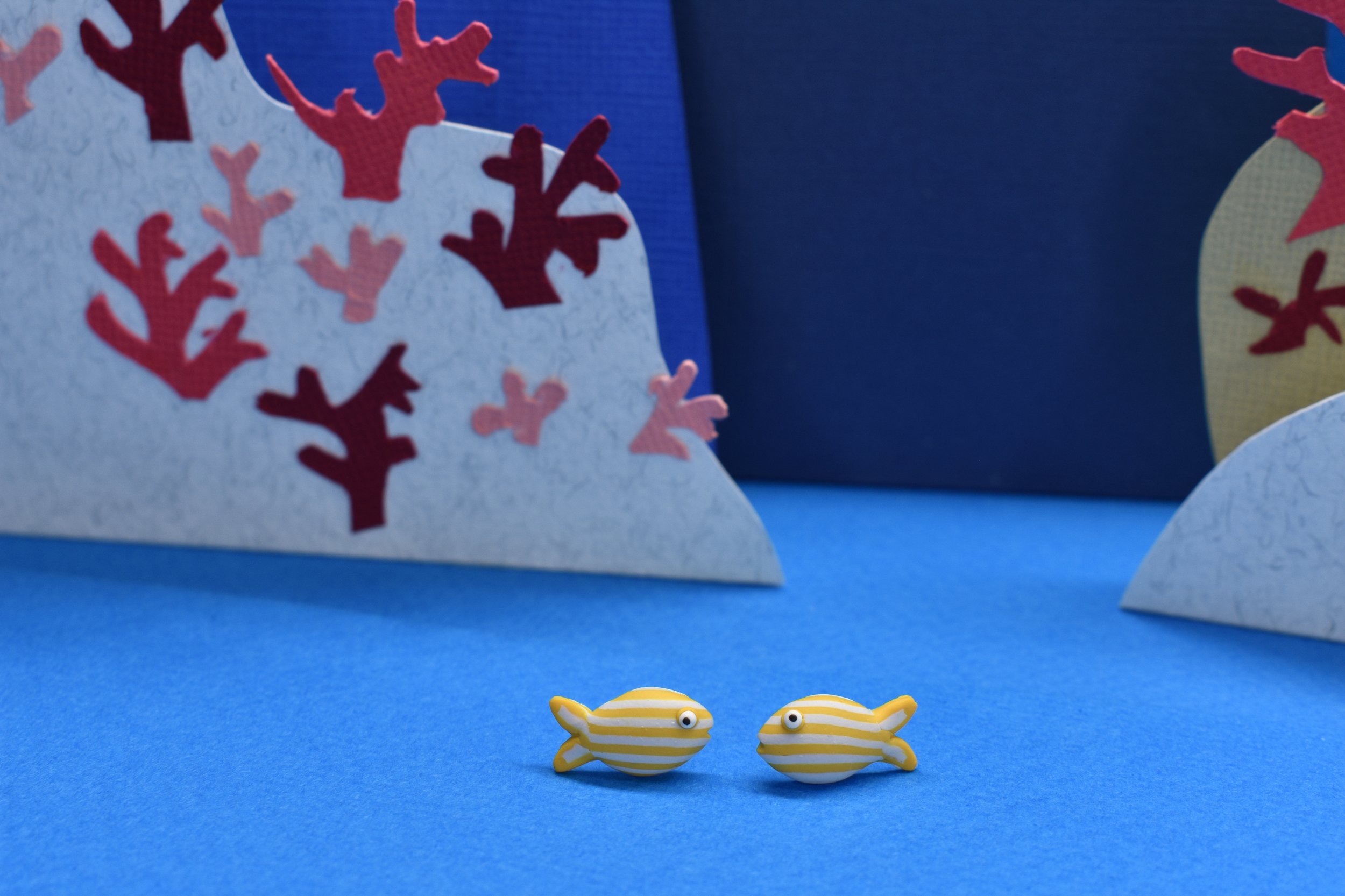 Goldline fish earrings with happy stripes.
