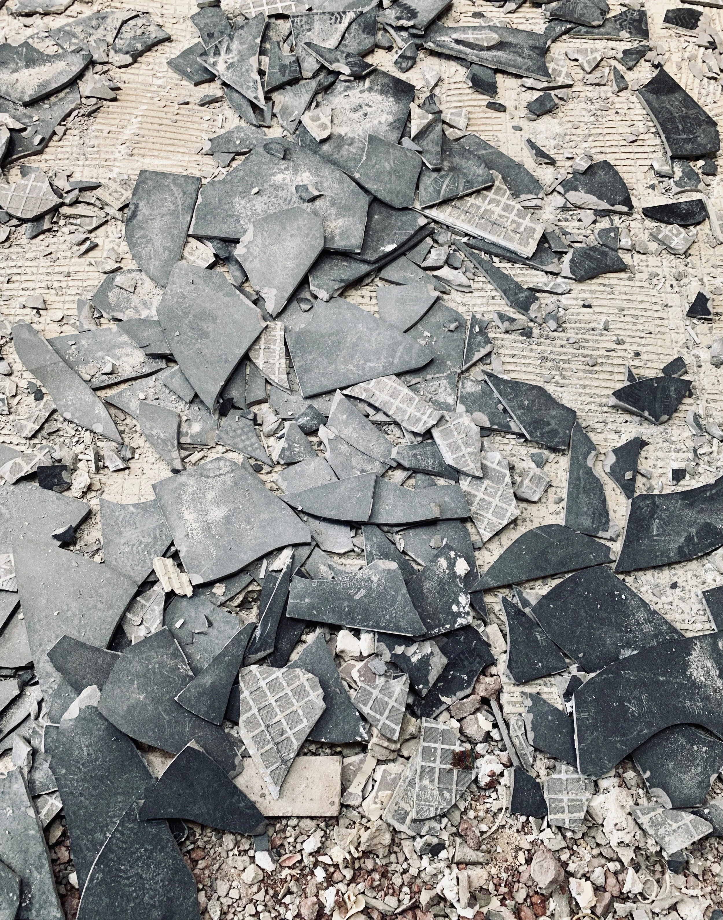 Débris de carreaux de céramique cassés sur le sol