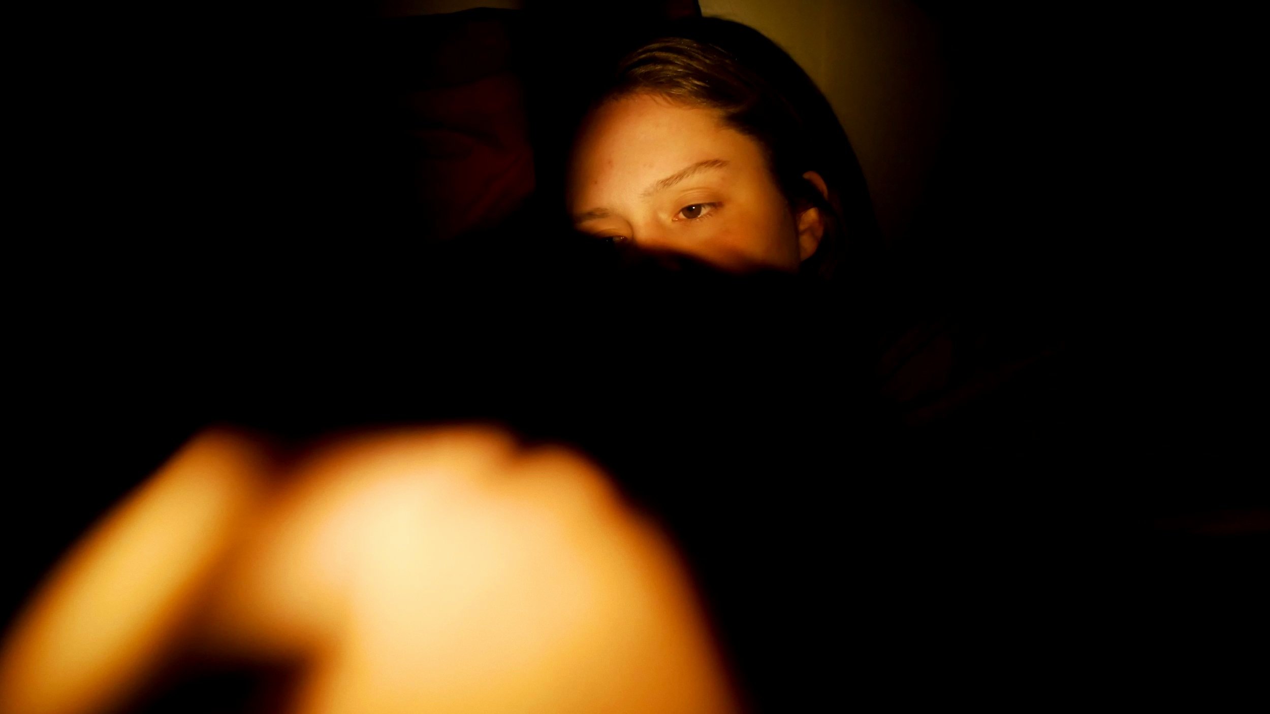 Carly Geary's face covered with shadows.