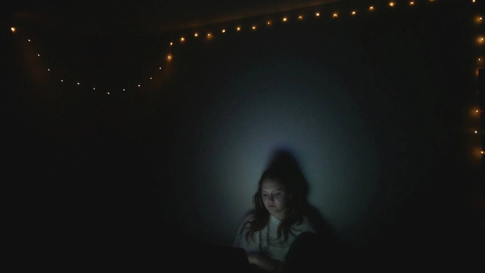 Carly Geary in a grey spotlight.