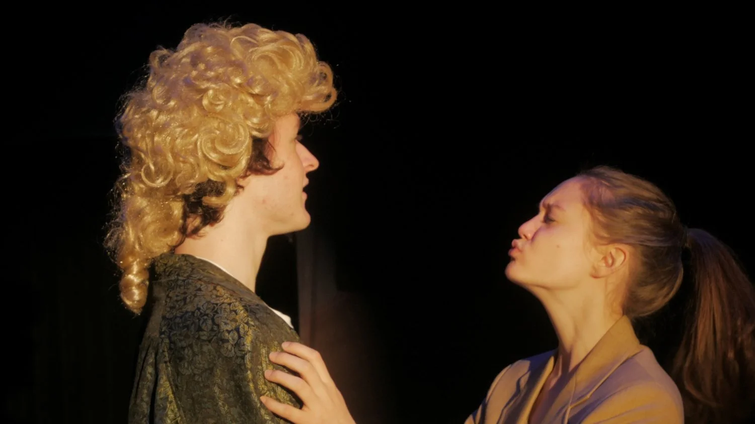 Carly Geary and Dominick Stefischski getting close to kissing in Jax Schuck's production of Rosencrantz and Guildenstern Are Dead.