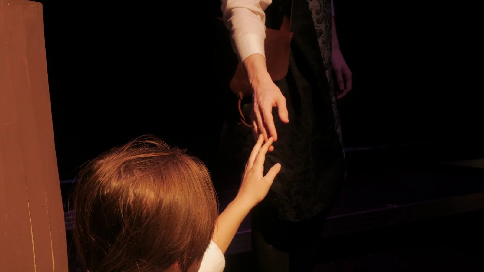 Avery Barstand and Blake Kump touch hands in Jax Schuck's production of Rosencrantz and Guildenstern Are Dead.