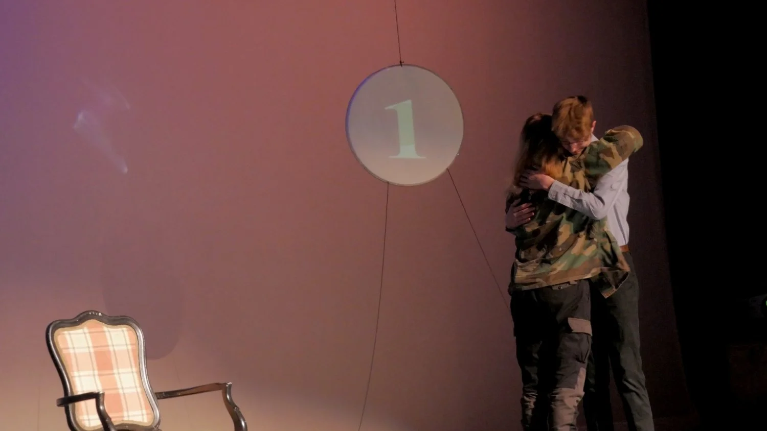 Mason Lester and Joan Patrello hugging in Jax Schuck's Entropy.
