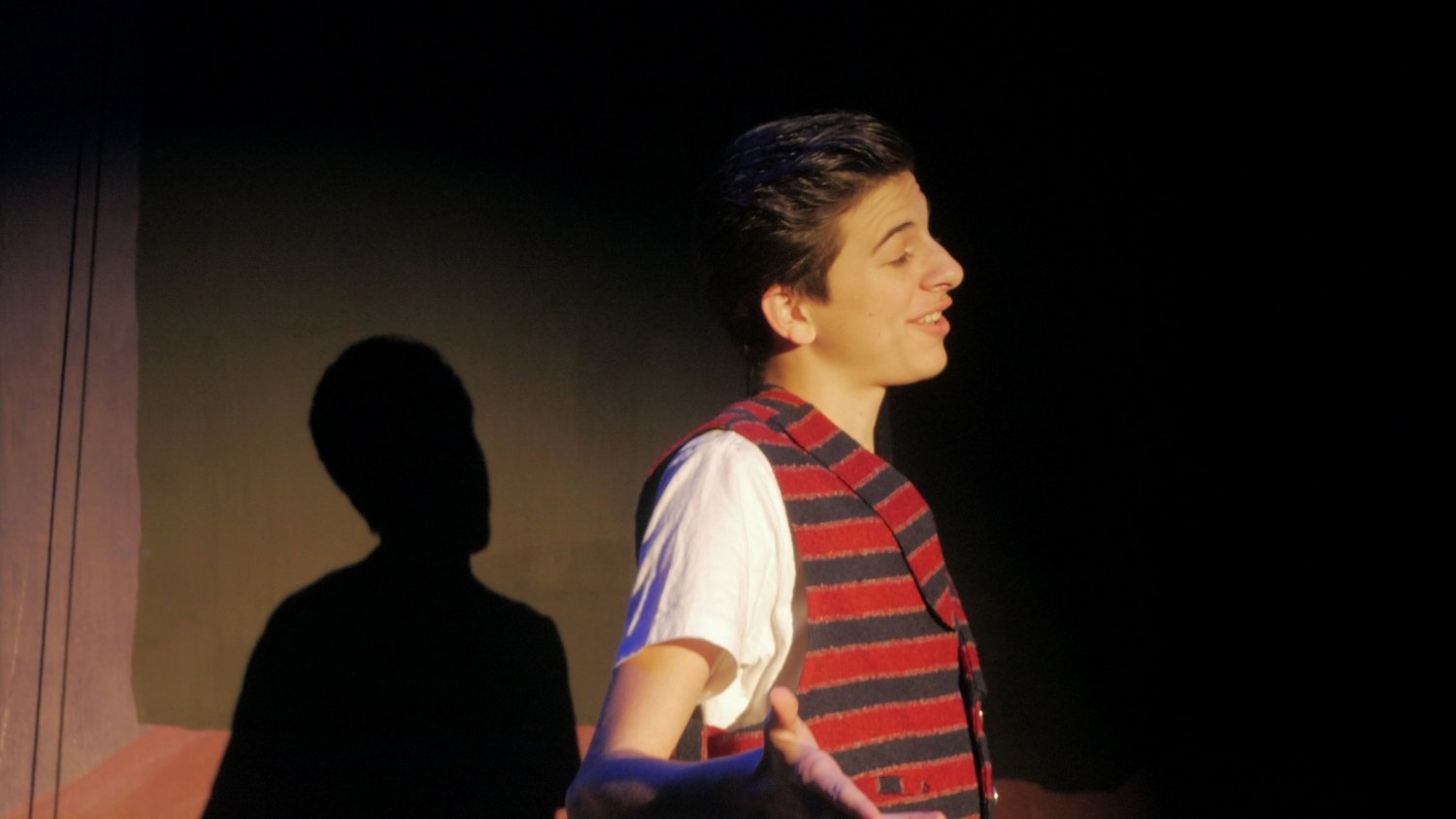 Felix David standing alone in Jax Schuck's production of Rosencrantz and Guildenstern Are Dead.
