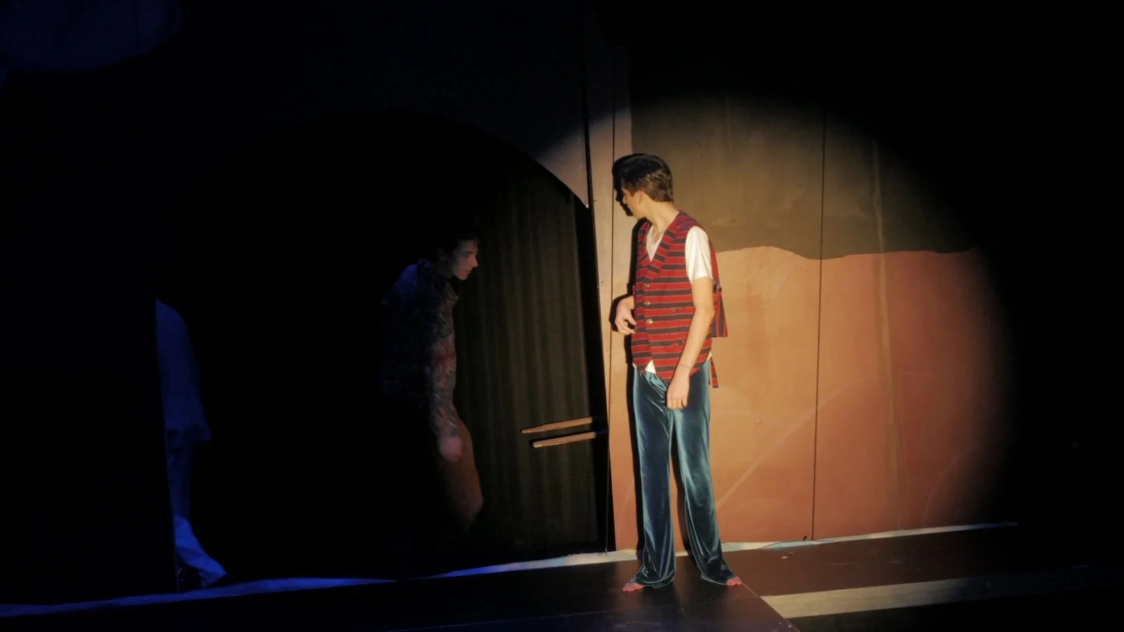 Felix David stands in a spotlight in Jax Schuck's production of Rosencrantz and Guildenstern Are Dead.
