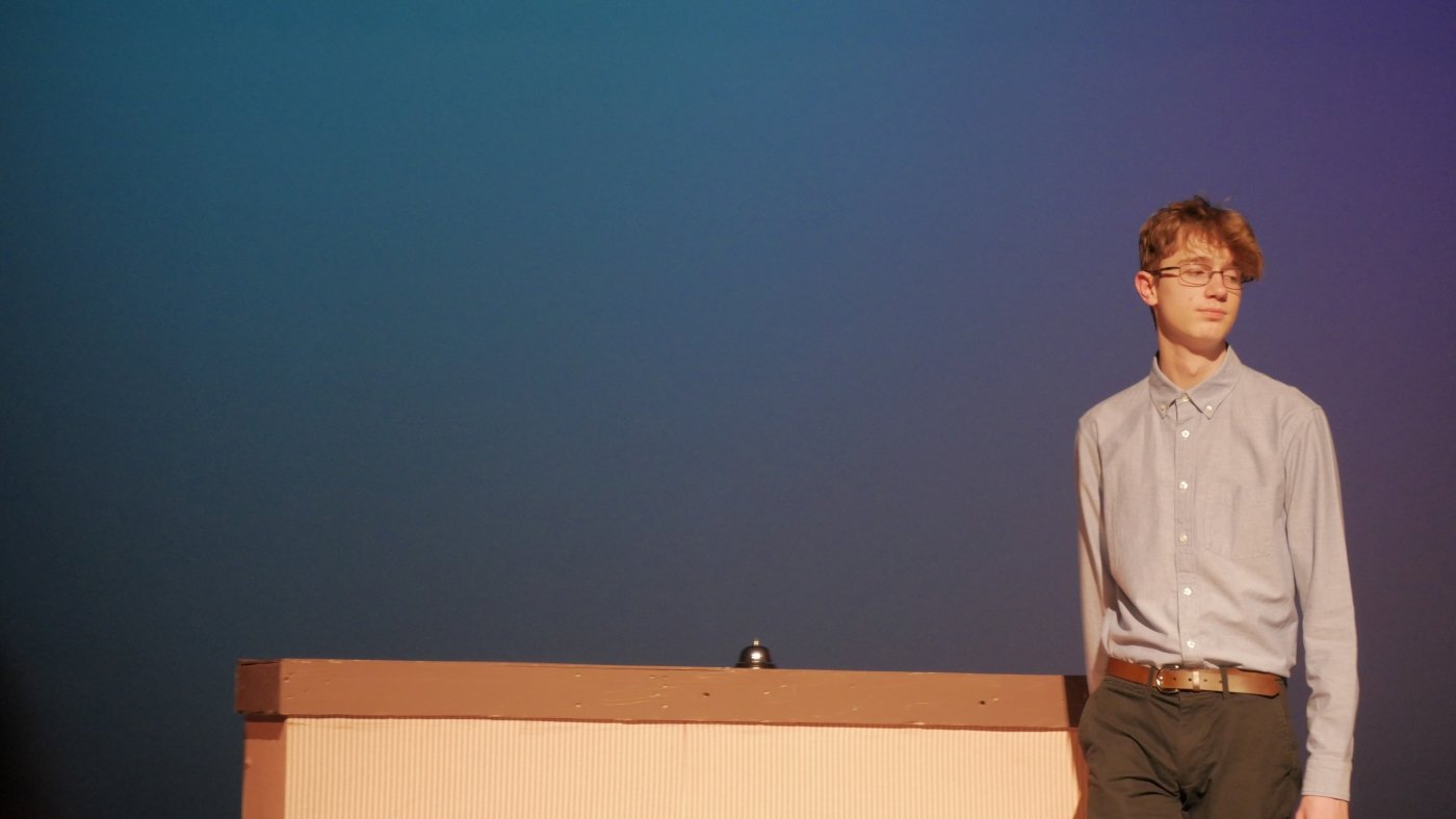 Mason Lester standing in front of a bell in Jax Schuck's Entropy.