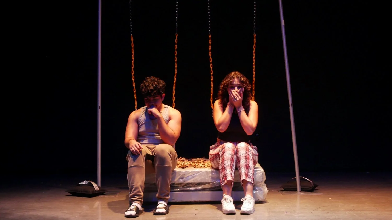 Erick Tuya and Dina Zeid covering their faces in Jax Schuck's The Tie.